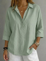 Blusa con botones a presión y manga 3/4