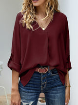 Blusa plisada elegante con cuello en V y manga larga
