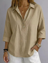 Blusa con botones a presión y manga 3/4